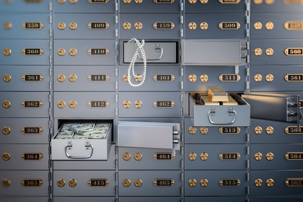 Open safe deposit boxes with cash and gold bars.