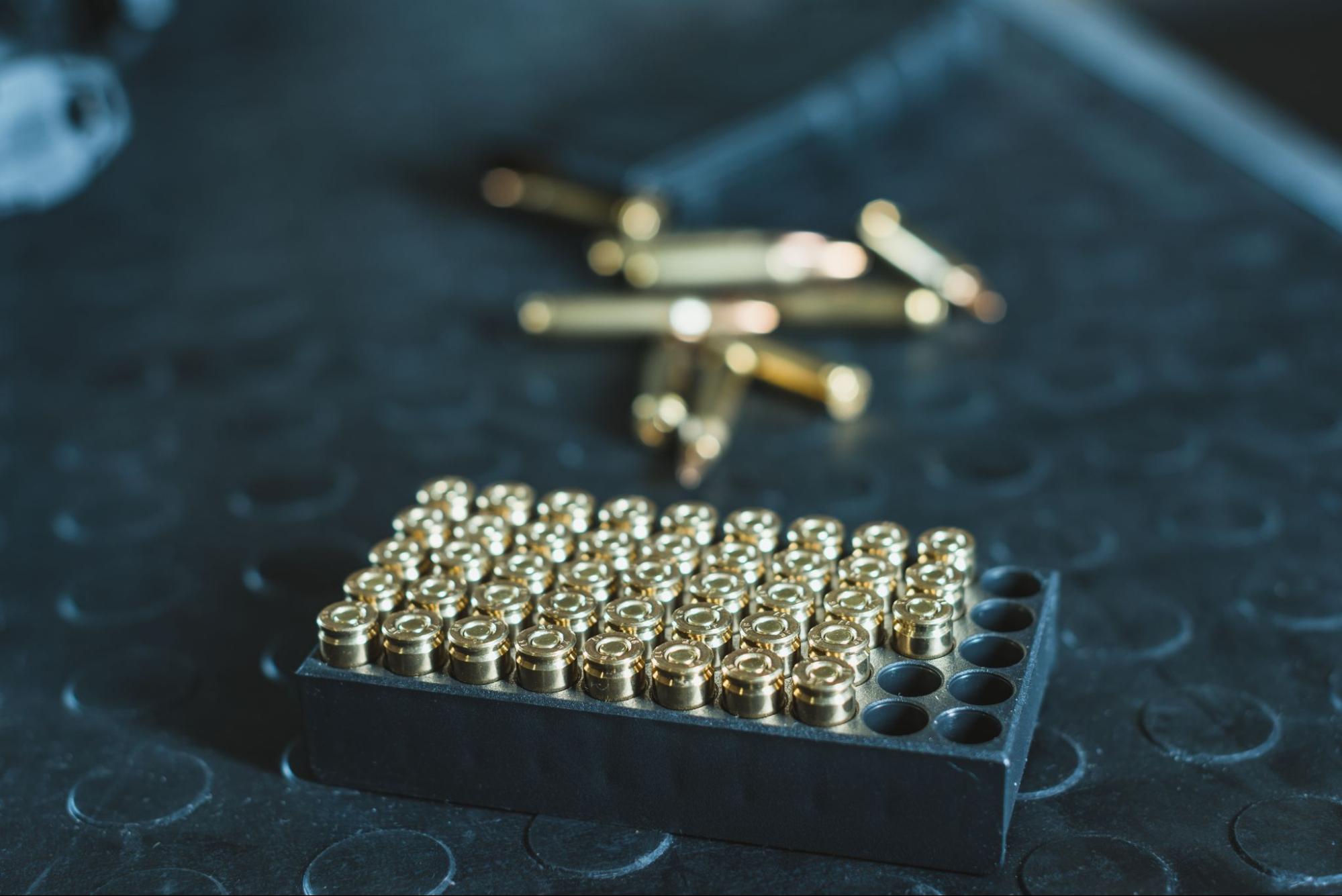 Box of ammunition on dark surface.