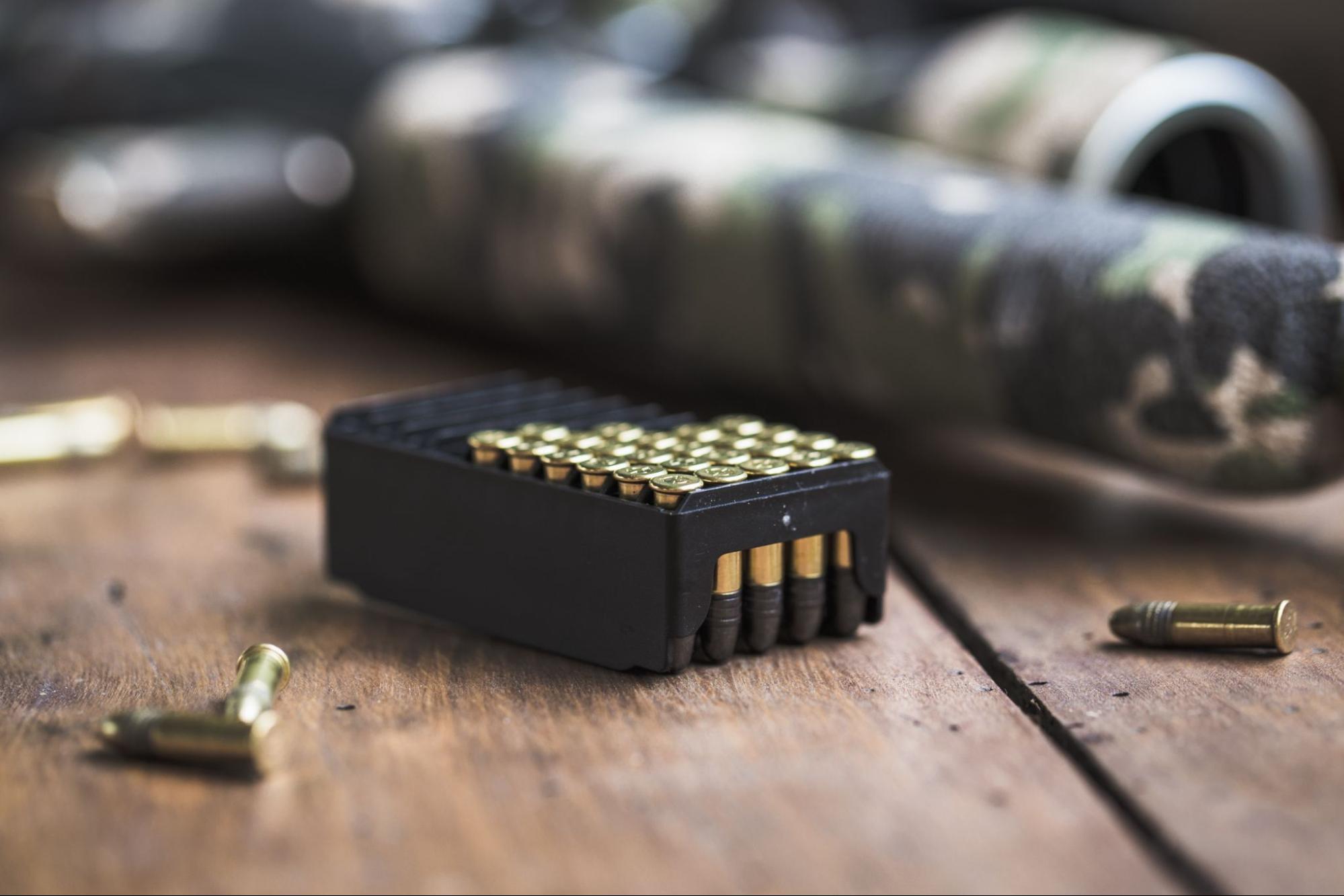 Box of bullets on wooden surface