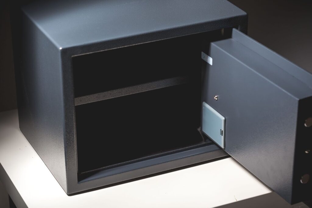 Open empty safe on white surface